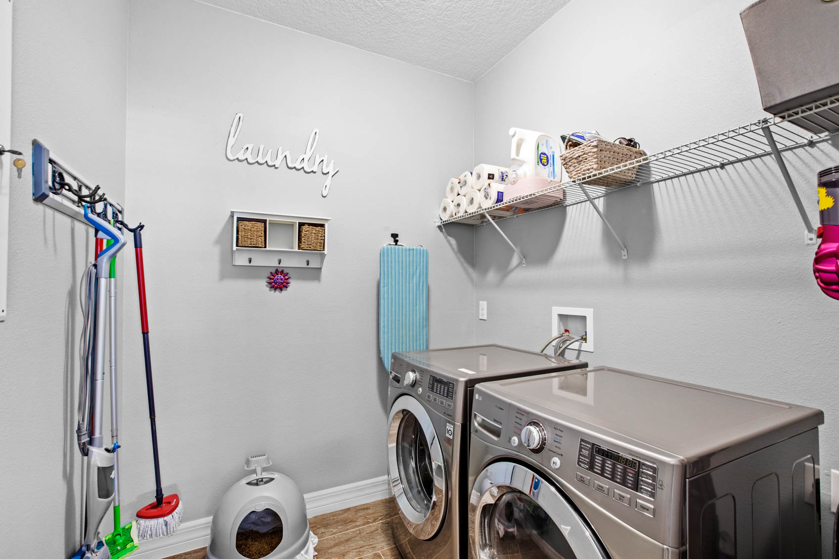 laundry room with grey machines